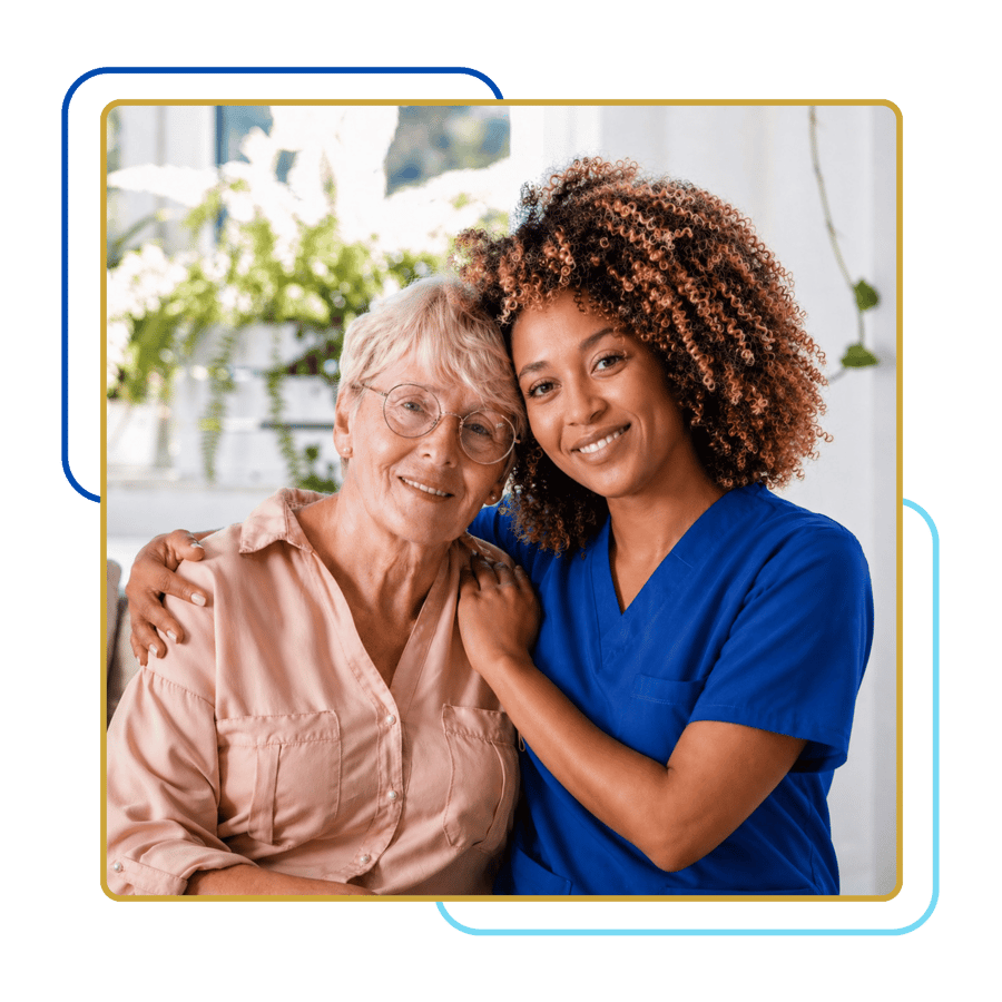A caregiver hugging a smiling senior woman
